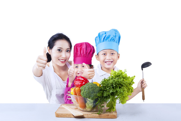 Happy family chef prepare vegetable meal on white - Фото, зображення