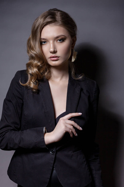 Portrait of a beautiful woman in a black jacket.  - Фото, изображение