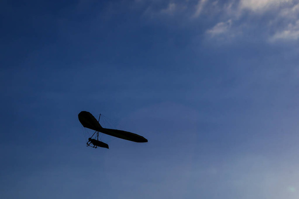 Hang-glider silhouette in sky in sunset time - Photo, Image