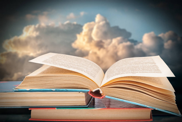 books against the blue sky with clouds - Photo, Image