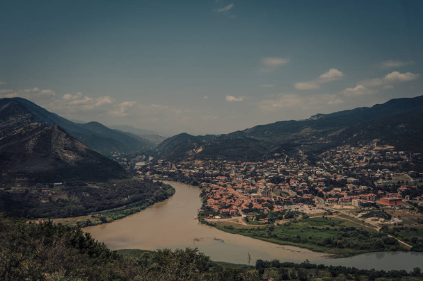 Aerial view on old town Mtskheta and confluence of the rivers Kura and Aragvi - Photo, image