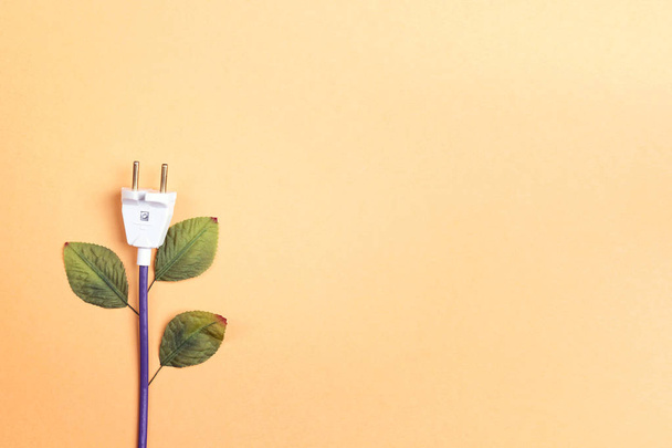 Electrical plug with leaves like a plant. Eco, bio, energy savin - Valokuva, kuva