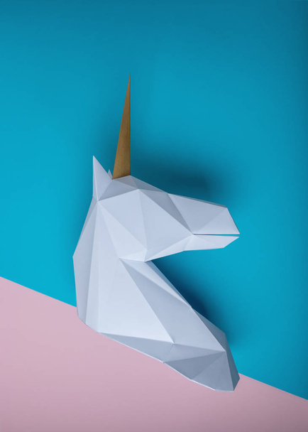 White 3d papercraft model of unicorn head on bright background. Minimal art concept. - Foto, afbeelding
