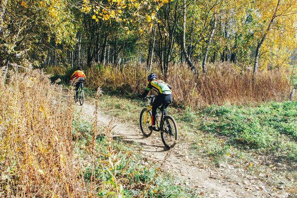 October 14, 2018 - Minsk, Belarus: 2018 Olympic Cross Country Cup XCO in Medvezhino, Two men riding bicycles along forest trail - Фото, зображення