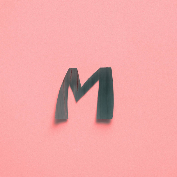 M One letter green tropical leaf alphabet pink - Φωτογραφία, εικόνα