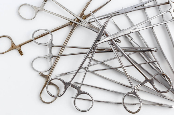 Vintage medische instrumenten, scalpel, schaar, clips en pincet op witte geïsoleerde achtergrond - Foto, afbeelding