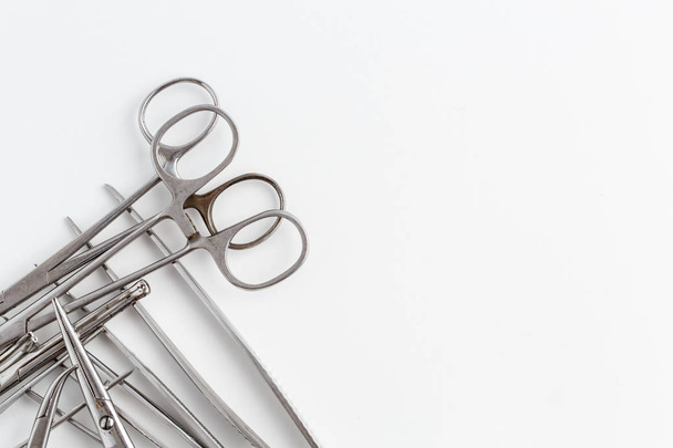 Vintage medical instruments, scalpel, scissors, clips and tweezers on white isolated background - 写真・画像