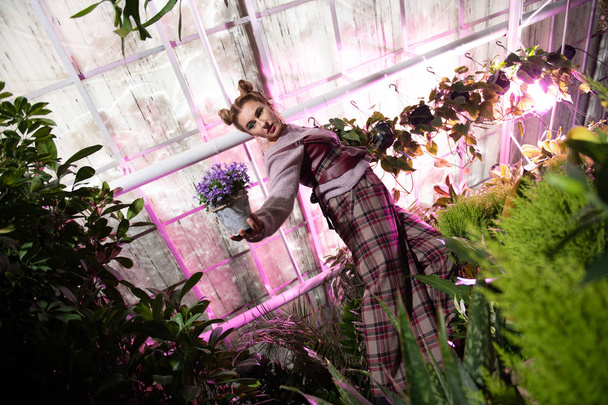 Attractive young woman being in the flower garden - Fotografie, Obrázek