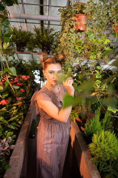 Nice pleasant woman standing among plants - Fotografie, Obrázek