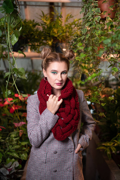 Portrait of a nice young woman wearing a red scarf - Zdjęcie, obraz