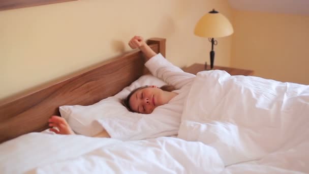 Young woman waking up in bedroom - Video, Çekim