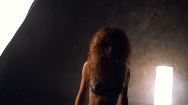 Young slim woman with red hair posing in lingerie - Footage, Video