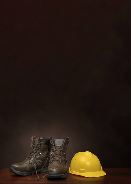 Boots and Construction Helmet on Brown With Copy Space Vertical - Fotó, kép