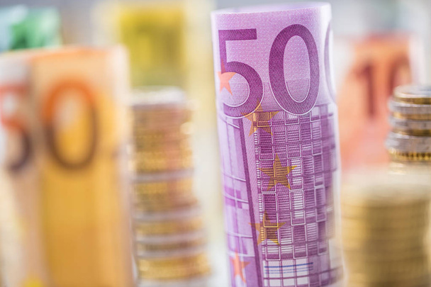 Rolled euro banknotes and coins towers stacked in other position - Foto, immagini