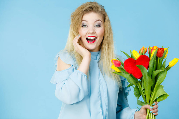 Pretty woman with red yellow tulips bunch - 写真・画像