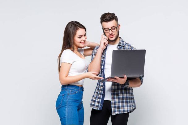 Young couple working with laptop isolated on white background - Zdjęcie, obraz