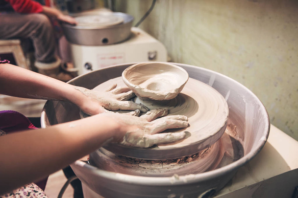 jeunes mains de potier travaillant avec de l'argile sur la roue de poterie
 - Photo, image