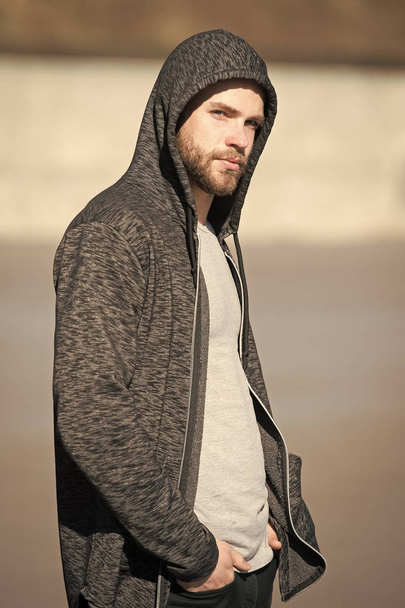 New day for achievements. Man handsome hooded guy enjoy sunrise after morning walk. Man feel motivated for new achievements. Sunny morning fill him energy charge. Motivation and inspiration concept - Photo, Image