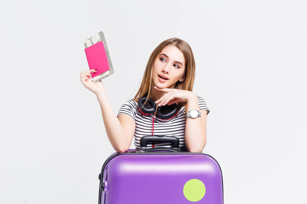young woman with suitcase and passport isolated on white background - Foto, immagini