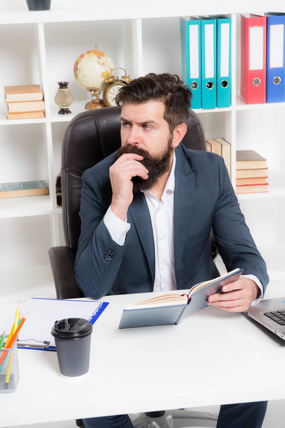 Busy boss in office. Check if i have time today. Man bearded hipster boss sit in leather armchair office interior. Boss at workplace. Manager formal clothing corporate style working. Business people - Photo, Image