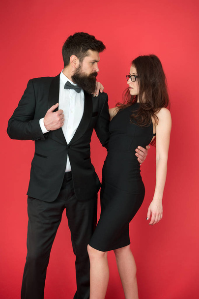 Award ceremony concept. Bearded gentleman wear tuxedo girl elegant dress. Formal dress code. Visiting event or ceremony. Couple ready for award ceremony. Corporate party. Gorgeous couple in love - Fotó, kép