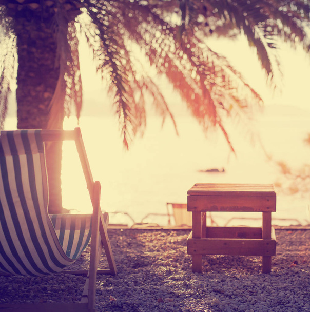 Summer vacation background with beach chair on resort coast - Fotoğraf, Görsel