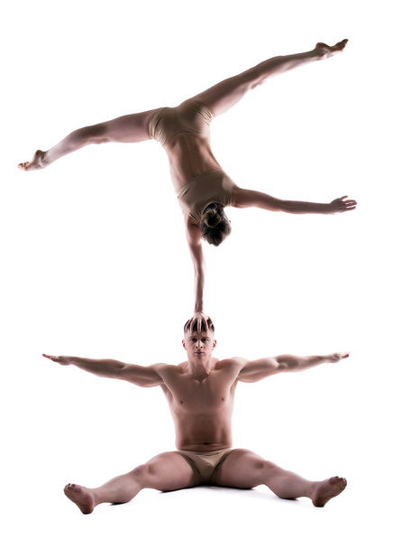 Athletic showing acrobatic trick in studio - Фото, зображення