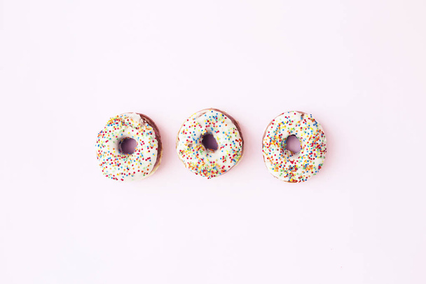 Top view of sweet glazed donuts on pink background - Photo, Image