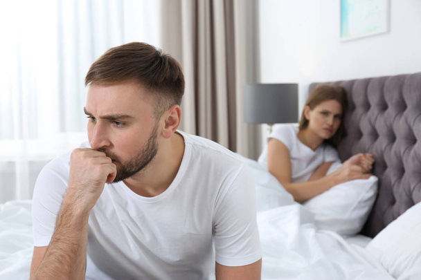 Young couple with relationship problems ignoring each other in bedroom - Foto, Bild