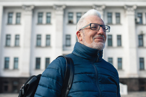 Active retirement concept. Portrait of handsome silver haired man - Фото, зображення