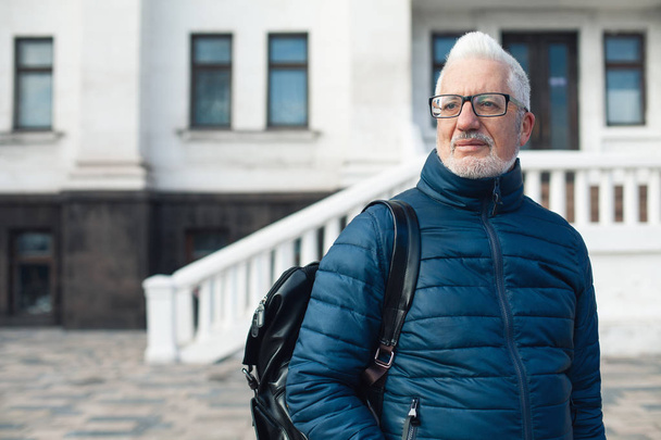 Active retirement concept. Portrait of handsome silver haired man - Фото, изображение