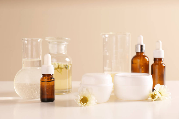 Skin care products, ingredients and laboratory glassware on table. Dermatology research - Foto, Bild