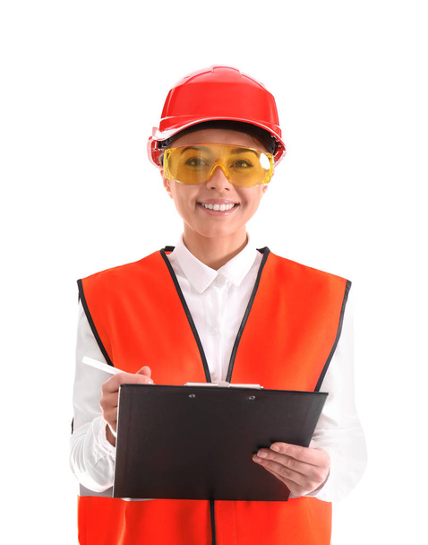 Female industrial engineer in uniform with clipboard on white background. Safety equipment - Photo, image
