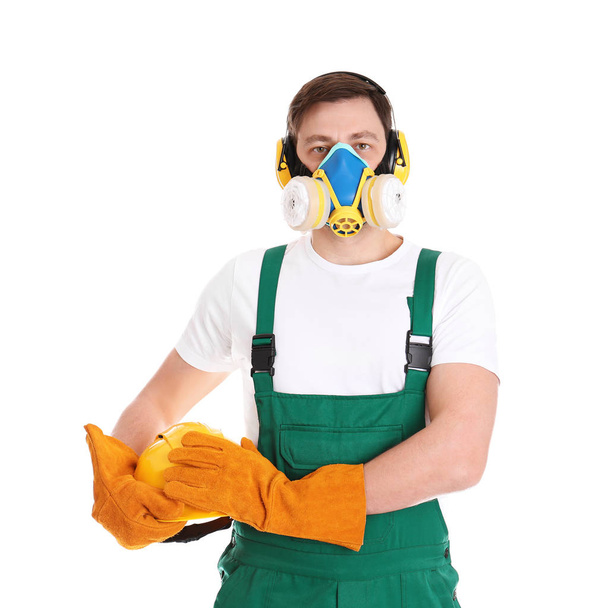 Male industrial worker in uniform on white background. Safety equipment - Foto, imagen