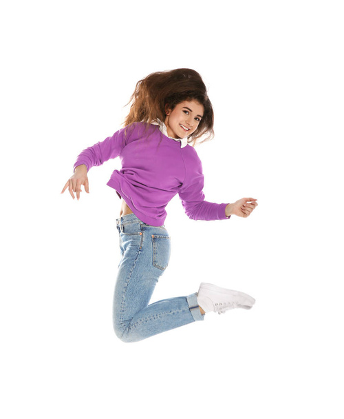 Beautiful young woman in stylish clothes jumping on white background - Foto, afbeelding