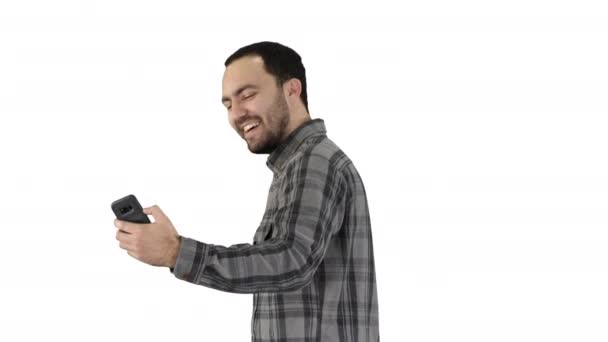 Young man taking selfie picture with smart-phone on white background. - Filmmaterial, Video