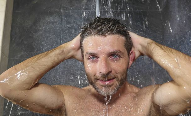 natural face portrait of young attractive and happy man at home or gym bathroom enjoying morning shower washing his hair with shampoo relaxed and cheerful - Photo, Image