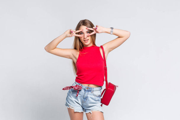 Pretty woman wearing red t-shirt and looking at camera isolated on white background - Φωτογραφία, εικόνα