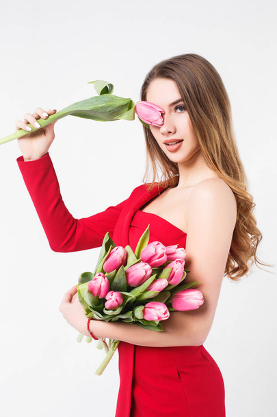 Beautiful young woman with pink tulips isolated on white background - Fotoğraf, Görsel