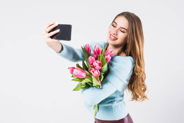 Young smiling woman making selfie isolated on white background - Φωτογραφία, εικόνα