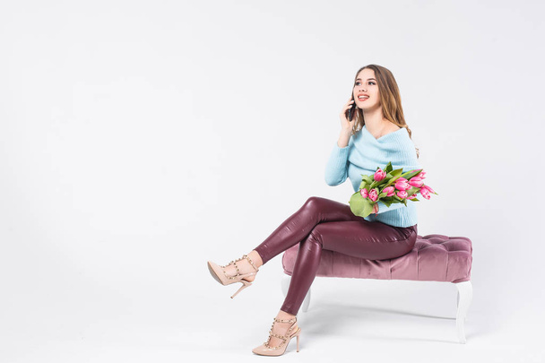 Happiness woman speaking by phone with beautiful pink tulips isolated on white background - Photo, Image