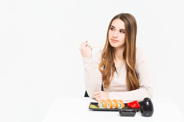 woman eating sushi isolated on white background - Foto, afbeelding