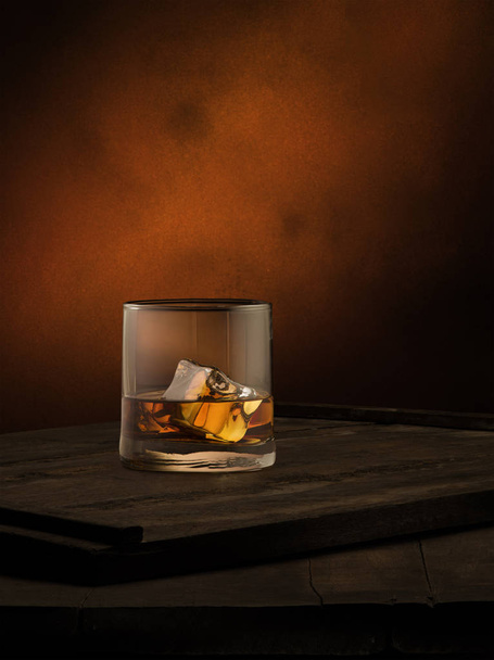 view of glass of  whiskey with ice  on color background.  - Photo, Image