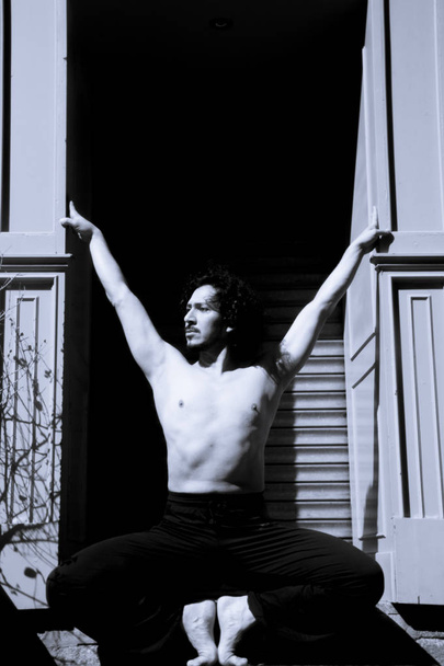 Latin male dancer posing with dancing figures - 写真・画像