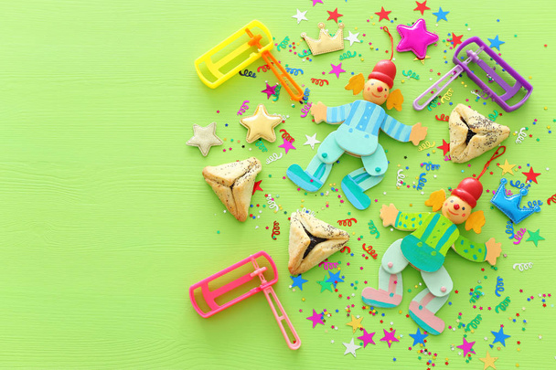 Purim celebration concept (jewish carnival holiday) over wooden green background. top view, flat lay - Fotó, kép