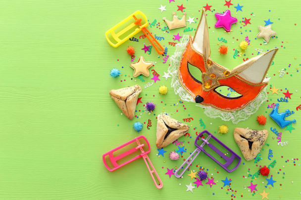 Purim celebration concept (jewish carnival holiday) over wooden green background. top view, flat lay - Valokuva, kuva