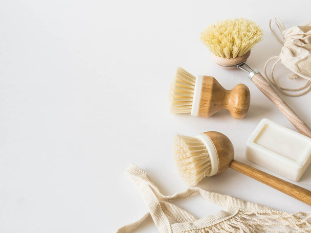 Dish washing brushes, bamboo toothbrushes, reusable bags. Sustainable lifestyle zero waste concept. Clean without waste. No plastic objects. - Zdjęcie, obraz