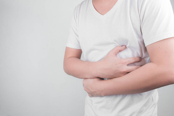 Asiatique Les jeunes hommes souffrent d'ulcères d'estomac. gastrite causée par l'infection de la bactérie H. pylori santé et problème de santé concept
 - Photo, image