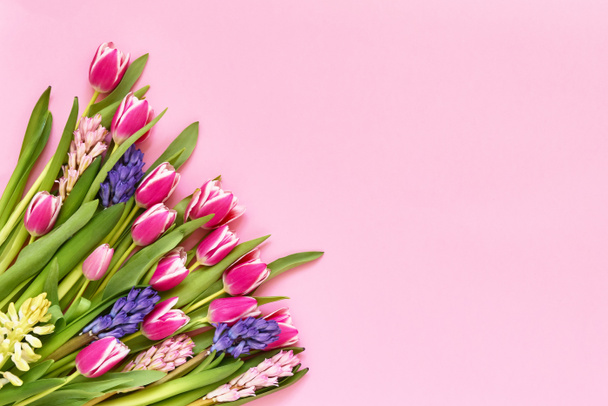 Spring flowers bouquet on pink background. Top view, copy space. - Photo, Image