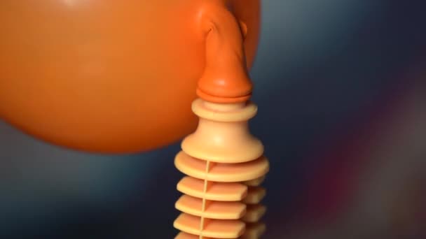 little kid's hand is science experimenting and testing the air pressure with orange balloon and bollow. - Кадры, видео